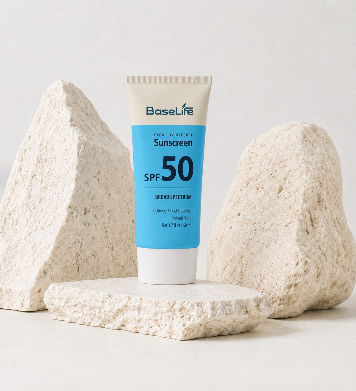 BaseLife Clear UV Defense SPF50 sunscreen on stone display